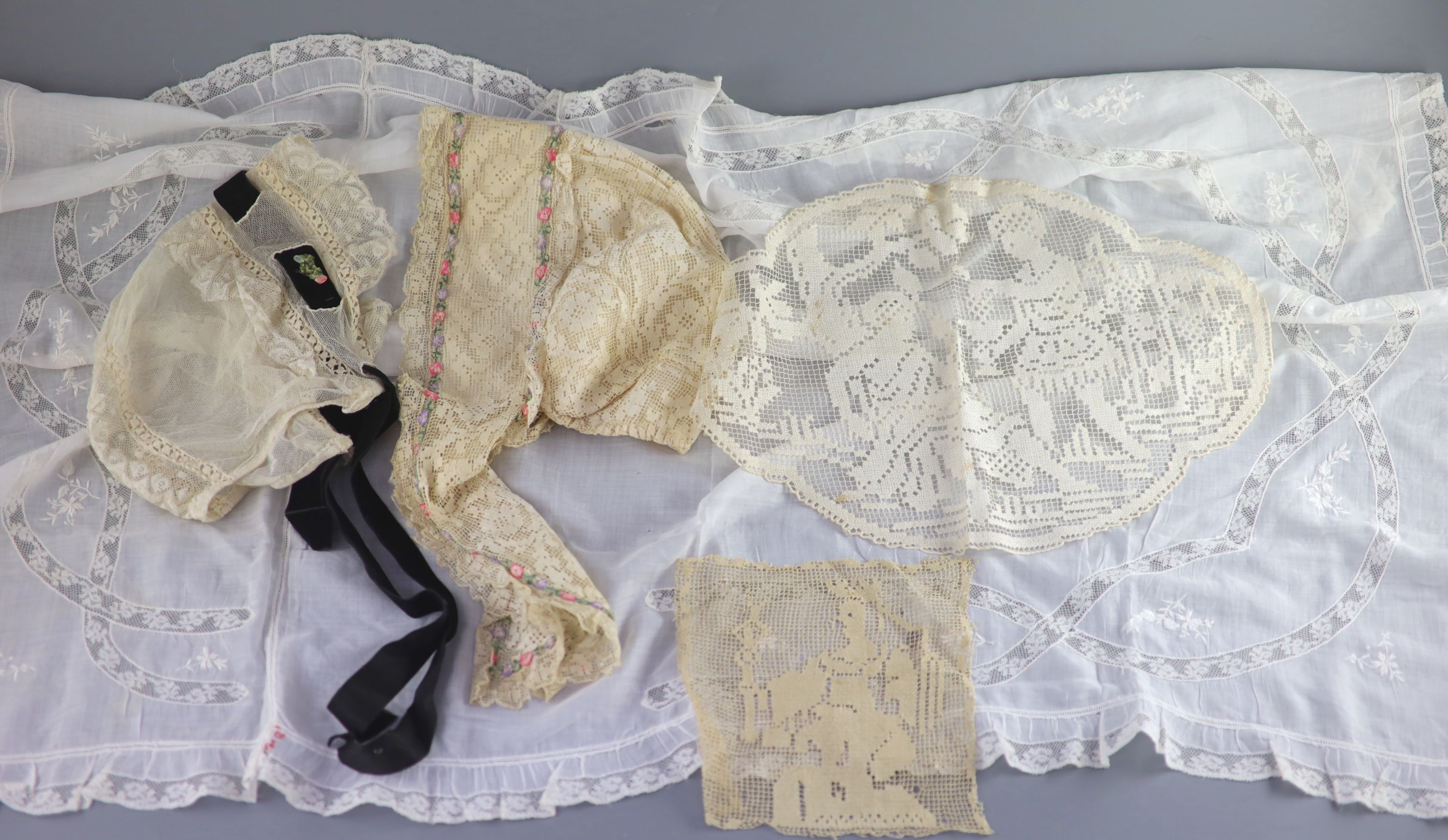 A fine white worked embroidered lace inset coverlet, a filet lace square of a figure wearing a crown (plus museum note),